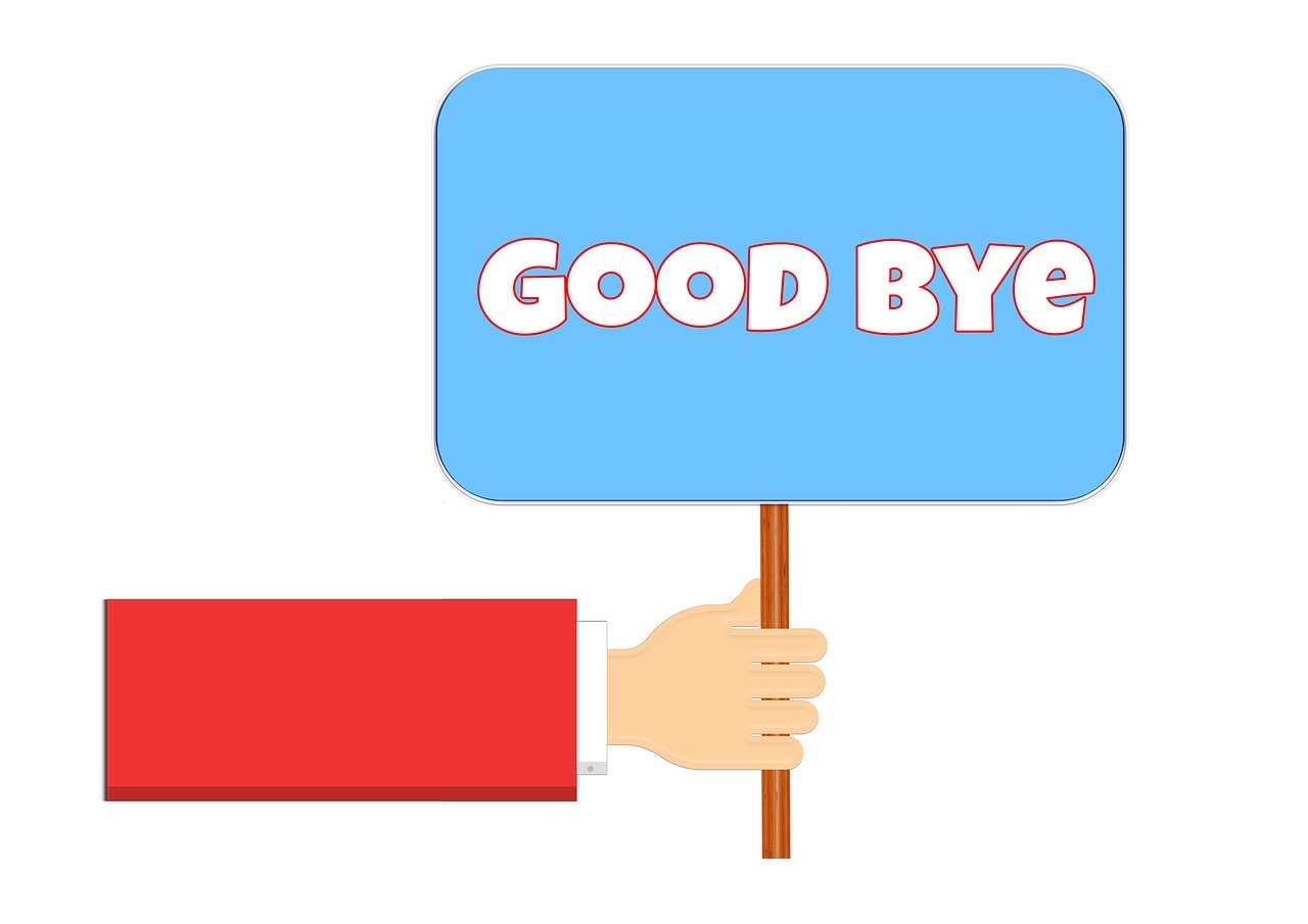 Good Byeと書かれたプラカードを持つ手